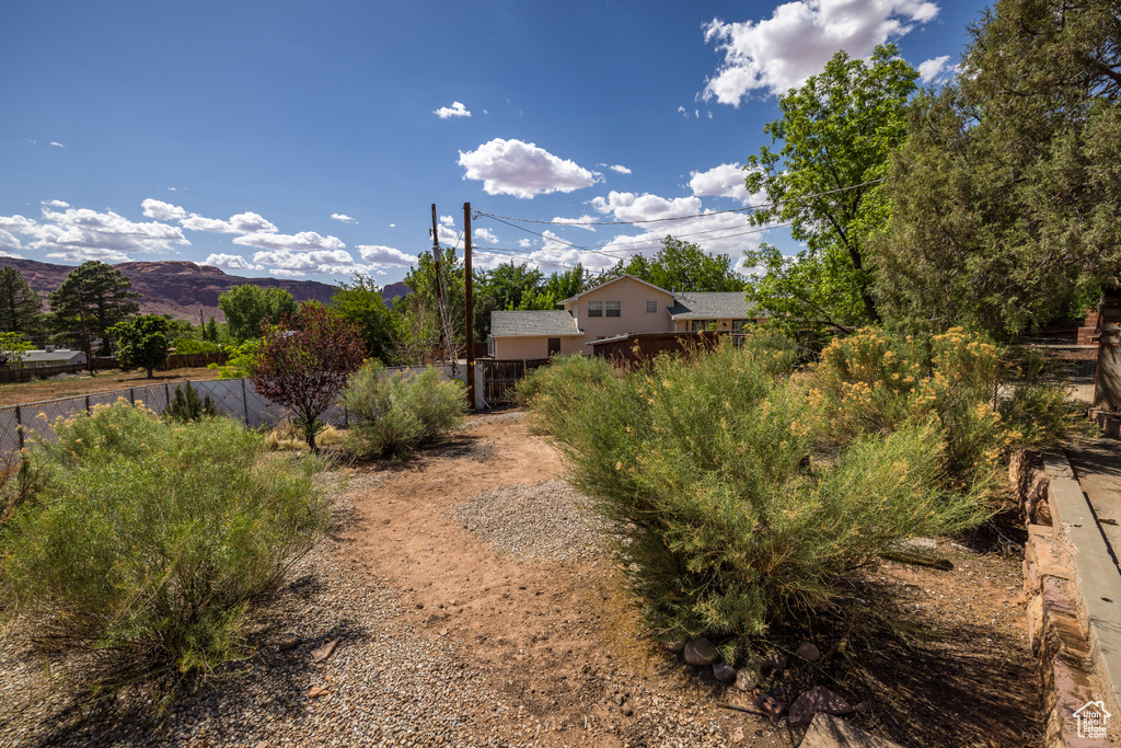 View of yard featuring fence and a mountain view