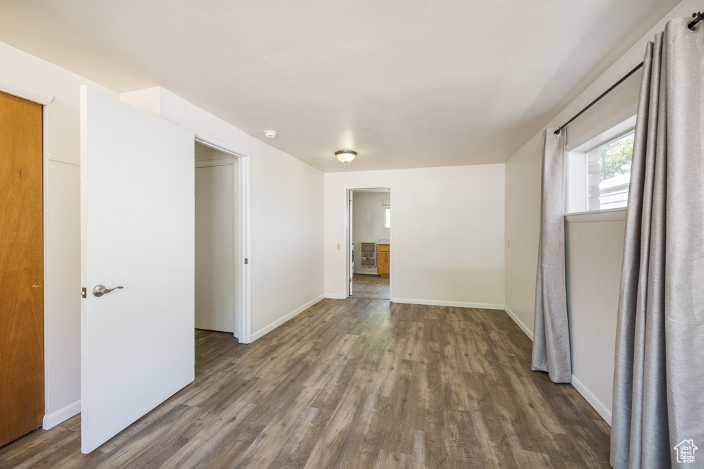 Spare room featuring wood finished floors and baseboards