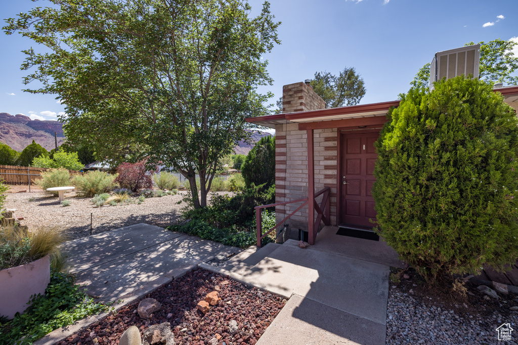 View of yard featuring a patio area, a mountain view, and fence