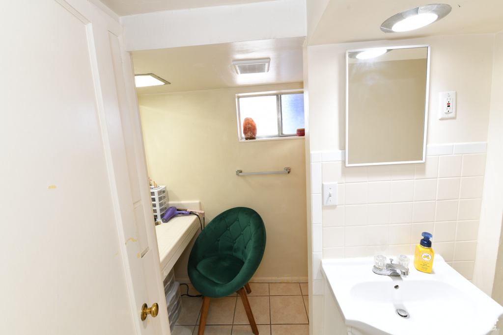 Bathroom featuring tile patterned flooring, tile walls, and vanity