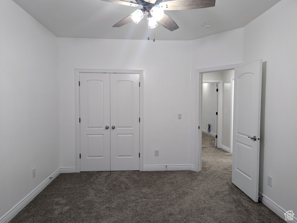 Unfurnished bedroom with carpet flooring and baseboards