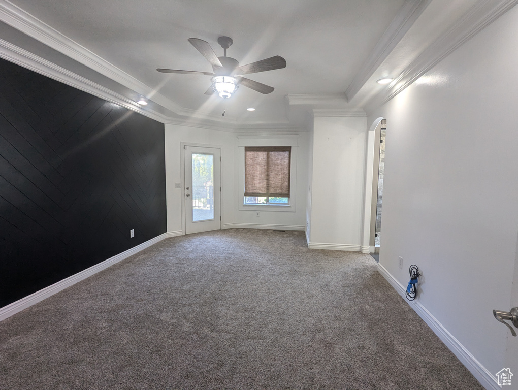 Carpeted spare room with arched walkways, ceiling fan, crown molding, and recessed lighting