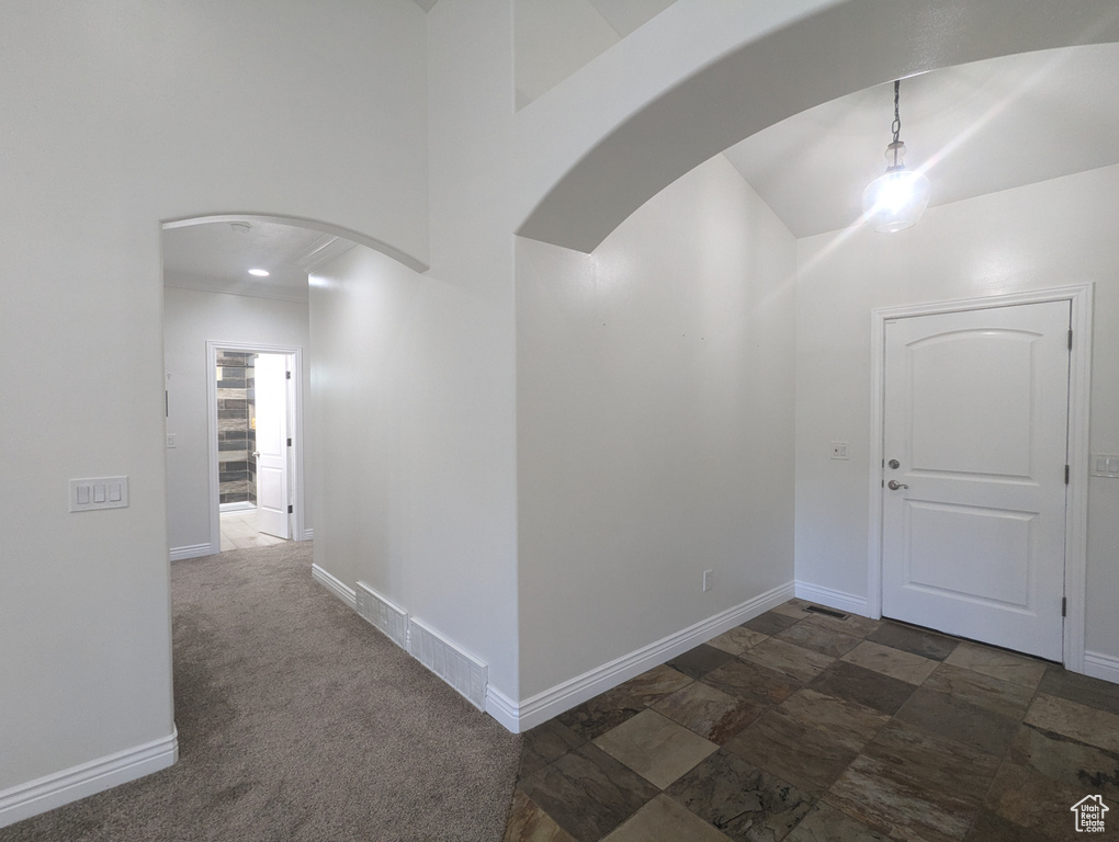 Corridor featuring arched walkways and a towering ceiling