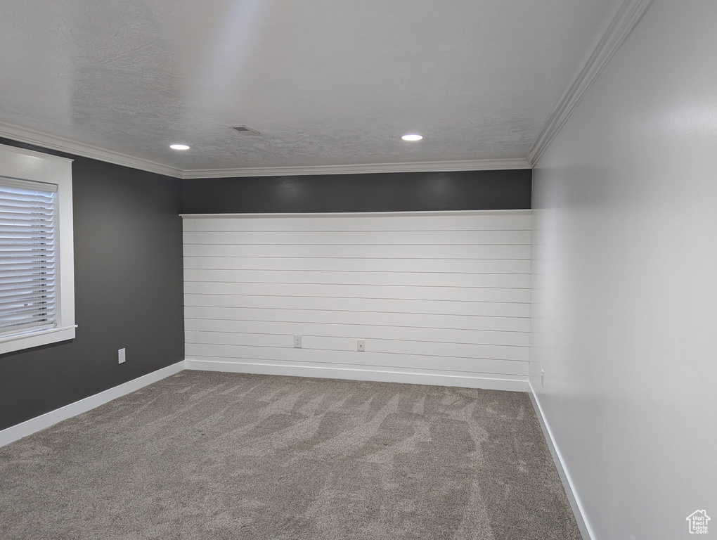 Empty room with carpet floors, baseboards, recessed lighting, and ornamental molding