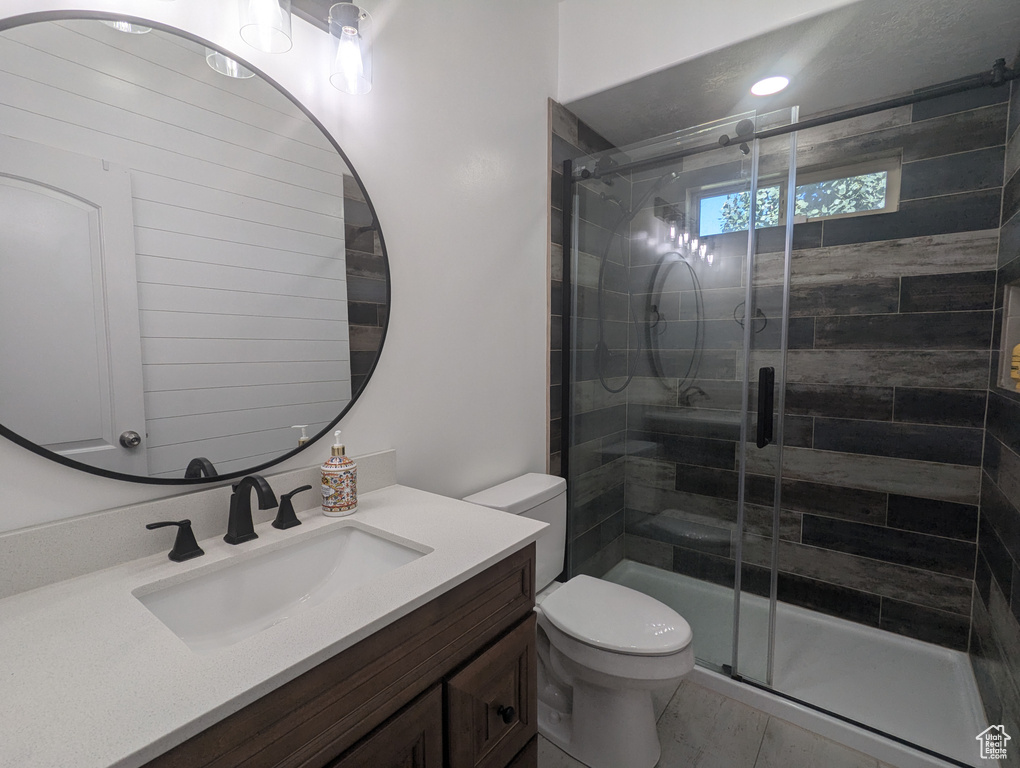 Full bath with vanity and a stall shower