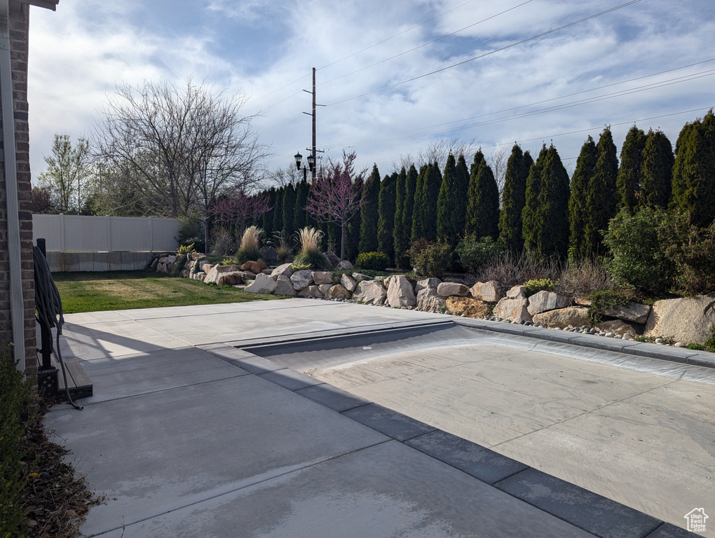 View of pool featuring fence and a patio area