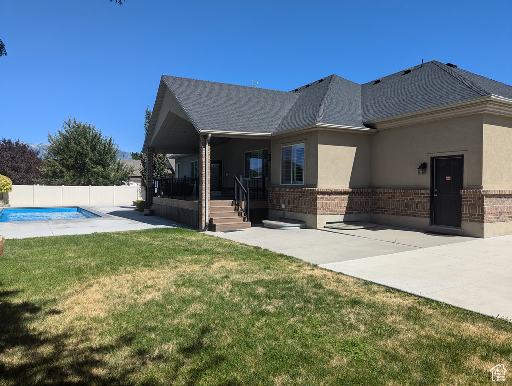 View of front of home with brick siding, stucco siding, and roof with shingles