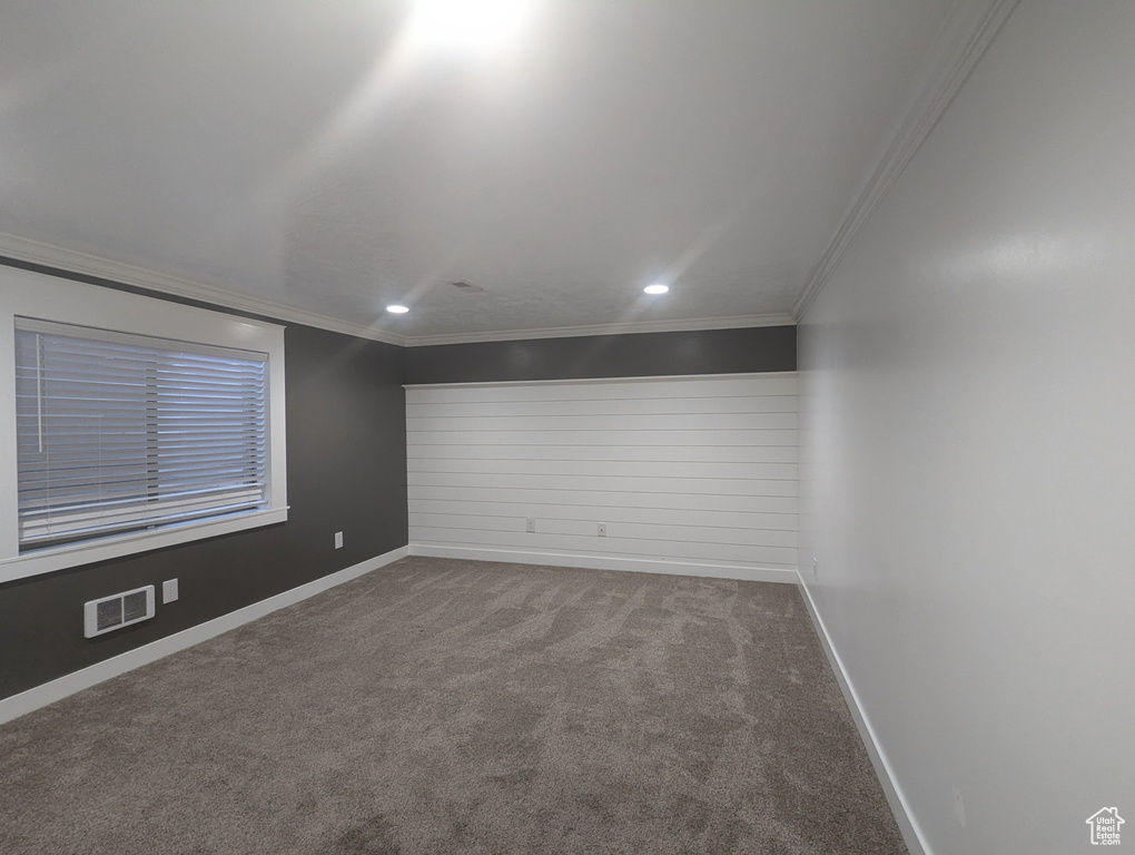 Spare room featuring carpet floors, ornamental molding, and recessed lighting