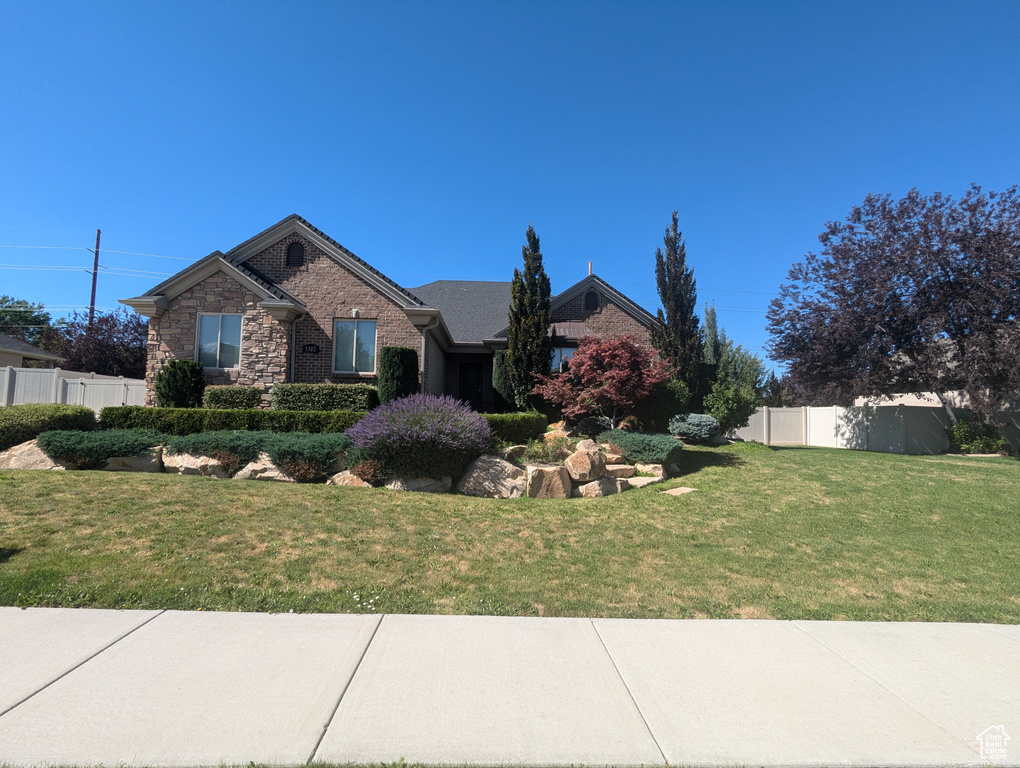 Ranch-style home featuring brick siding