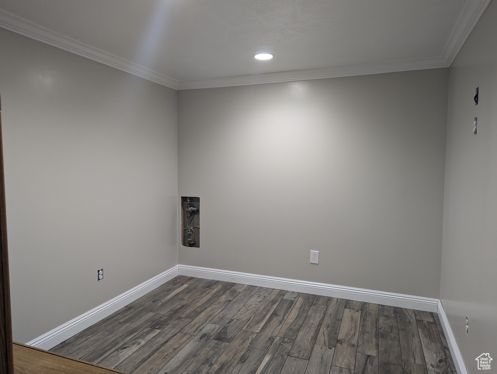 Spare room with baseboards, dark wood finished floors, ornamental molding, and recessed lighting