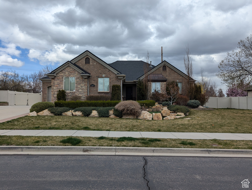 Ranch-style home featuring brick siding, driveway, and a garage