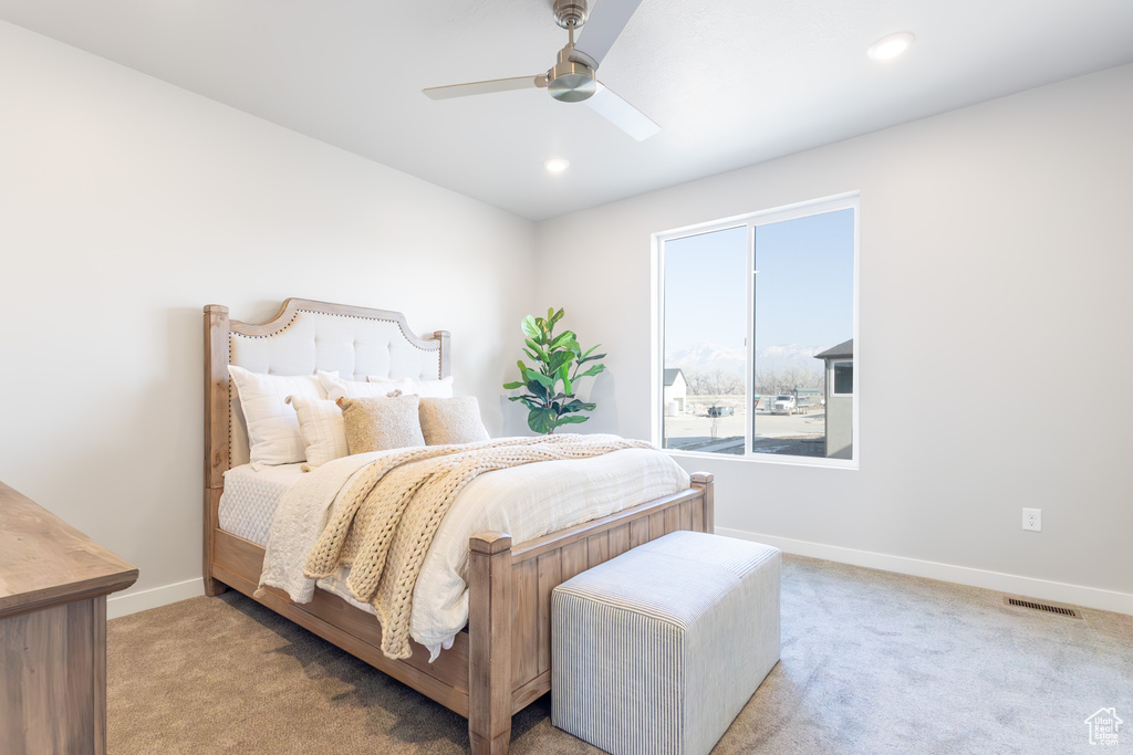 Bedroom with light colored carpet, baseboards, a ceiling fan, and recessed lighting