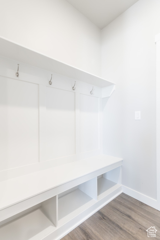 Mudroom featuring wood finished floors and baseboards