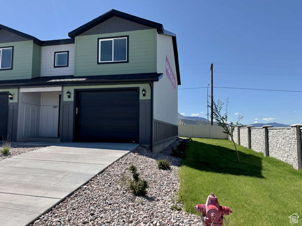 View of front of house featuring a garage and concrete driveway