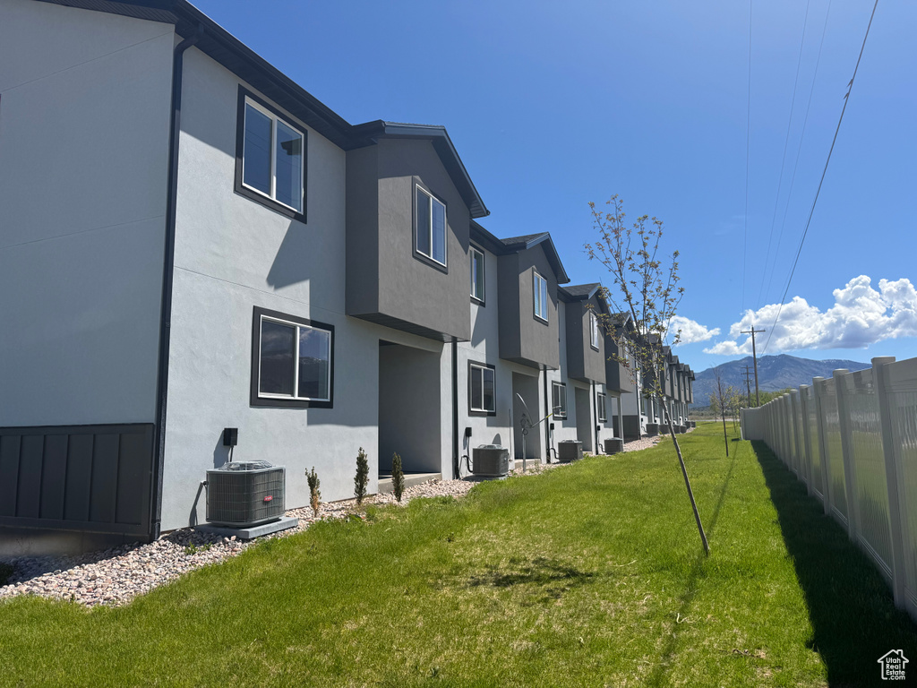 View of yard with central AC unit, a mountain view, and a residential view