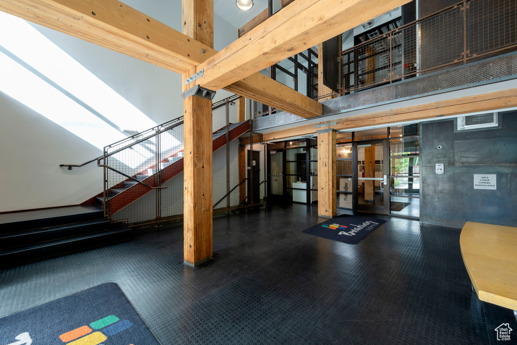 Building lobby featuring stairway and a towering ceiling