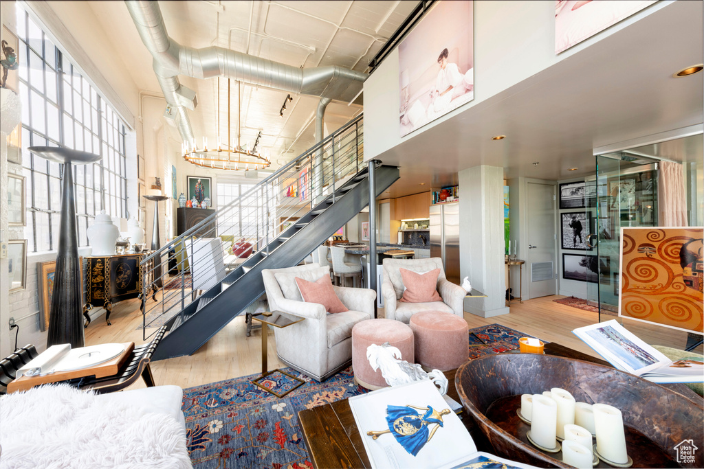 Common area with stairs and a towering ceiling