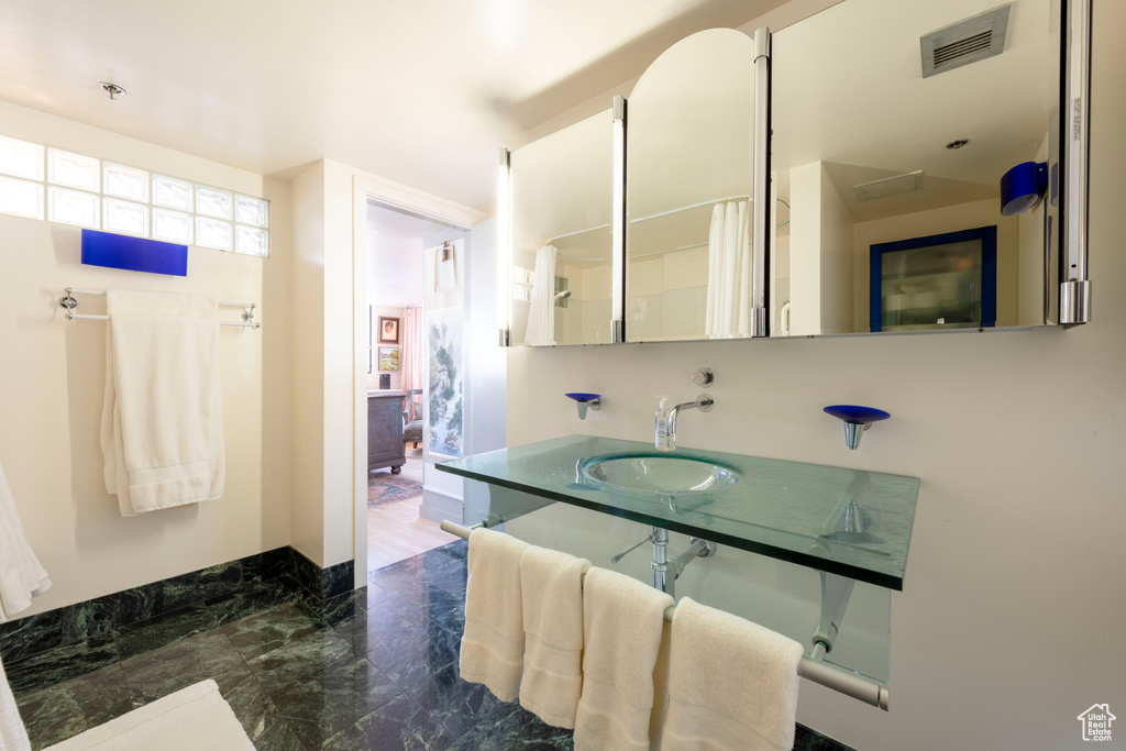 Bathroom with a sink and marble finish flooring