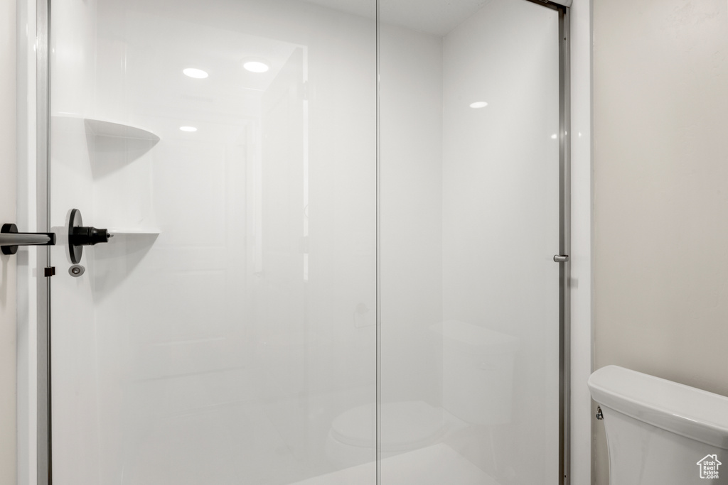 Full bathroom with toilet and a stall shower