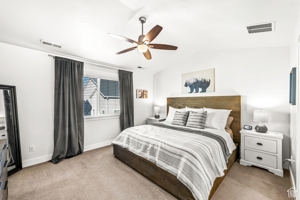 Bedroom with lofted ceiling, carpet, baseboards, and a ceiling fan