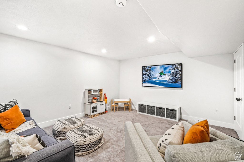 Carpeted living area featuring baseboards and recessed lighting