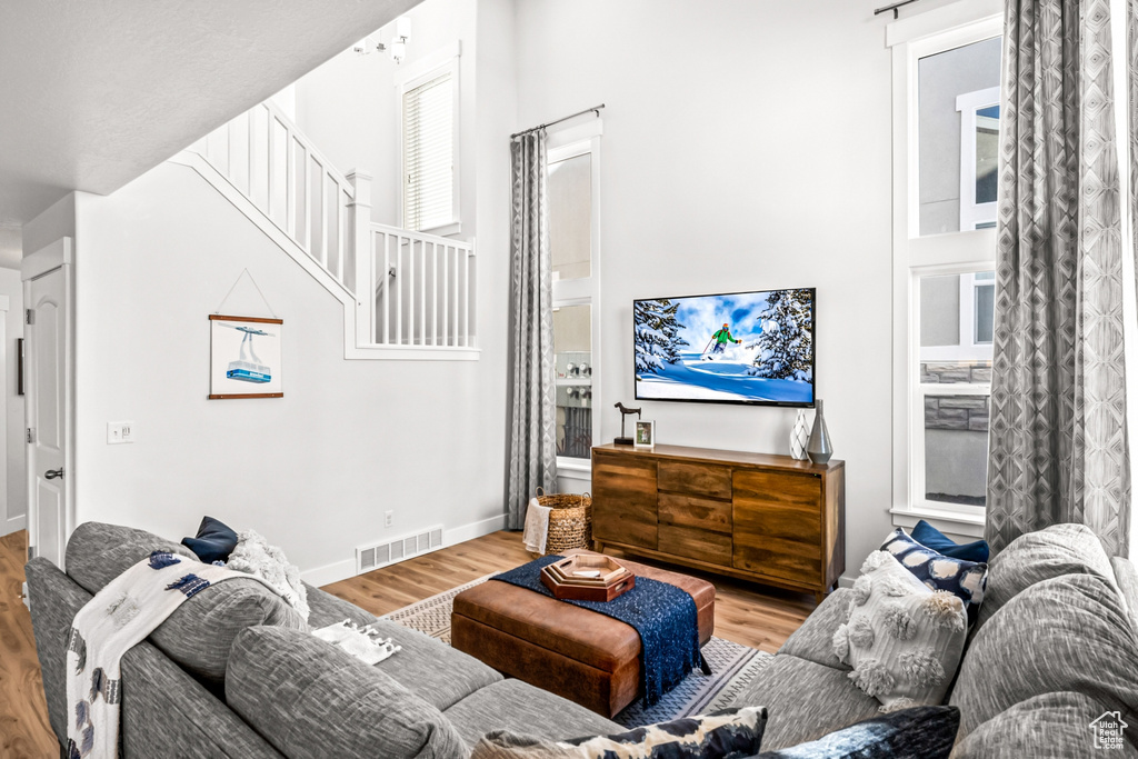 Living room featuring wood finished floors, stairs, and baseboards