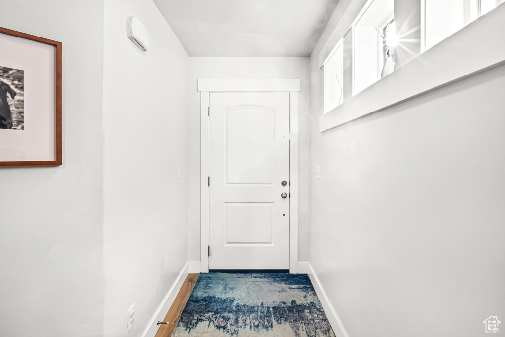 Doorway to outside with baseboards
