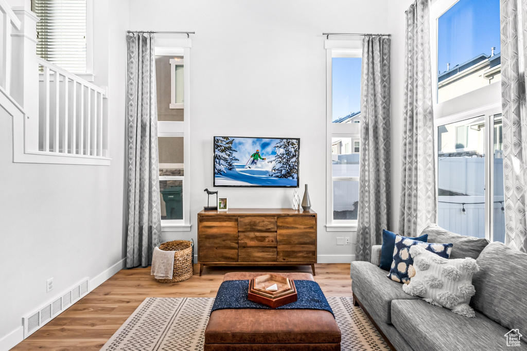 Living area featuring wood finished floors, plenty of natural light, and baseboards