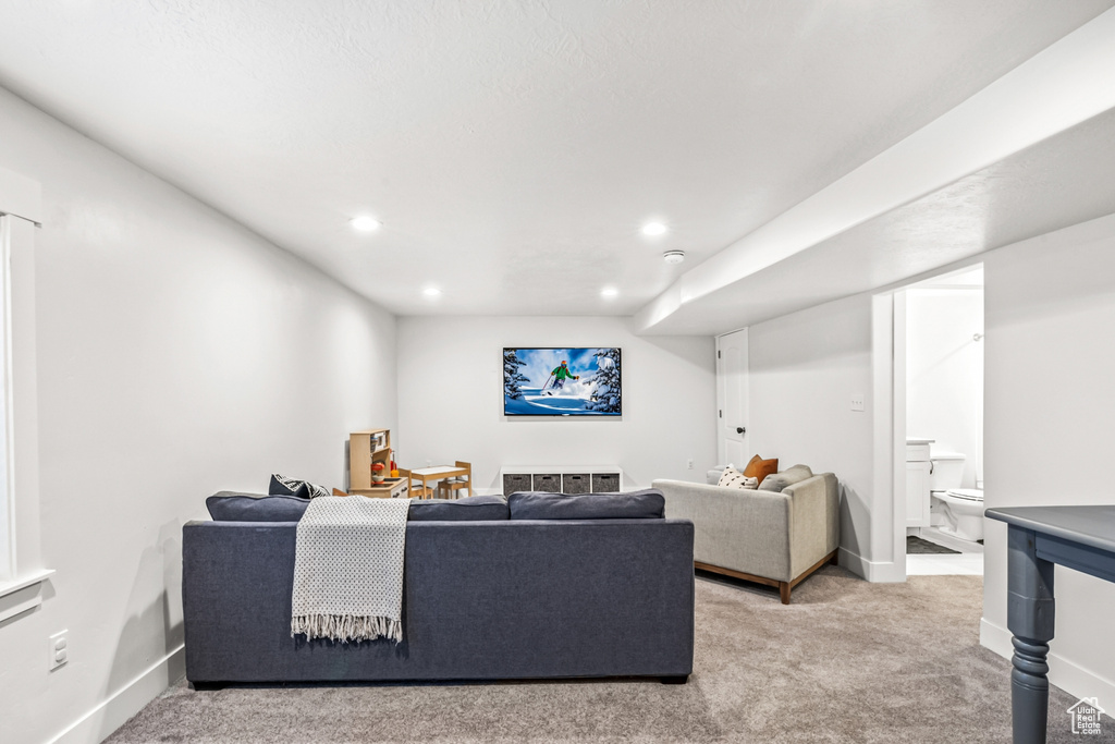 Living room featuring light carpet, baseboards, and recessed lighting