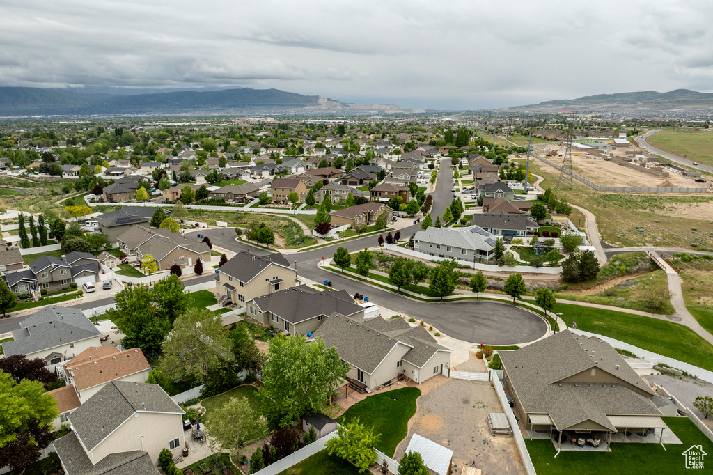 Aerial overview of property's location featuring nearby suburban area and mountains