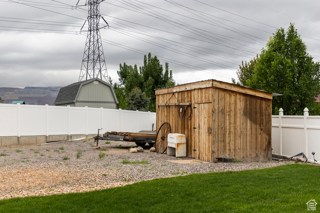 View of yard with a storage unit and an outdoor structure