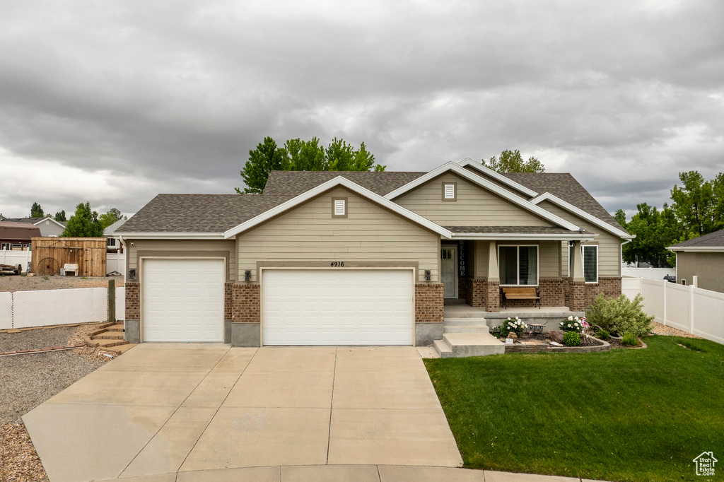 View of front of property with brick siding, an attached garage, driveway, and a shingled roof