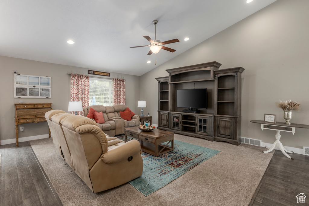 Living area with ceiling fan, wood finished floors, recessed lighting, lofted ceiling, and baseboards