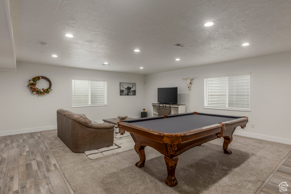 Game room featuring recessed lighting, pool table, light wood-type flooring, baseboards, and a textured ceiling