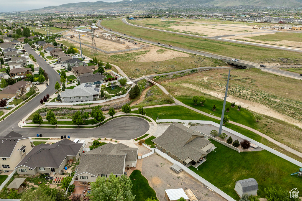 Aerial overview of property's location featuring a mountainous background and nearby suburban area