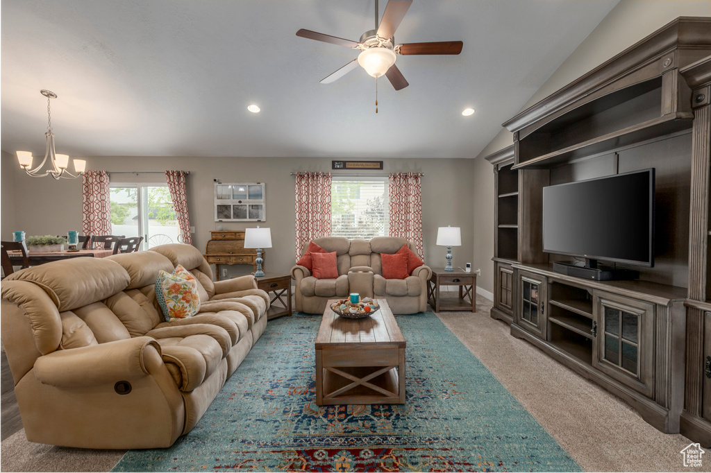 Living area with a chandelier, ceiling fan, recessed lighting, light carpet, and lofted ceiling
