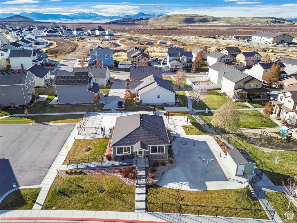 Aerial view of residential area featuring a mountainous background