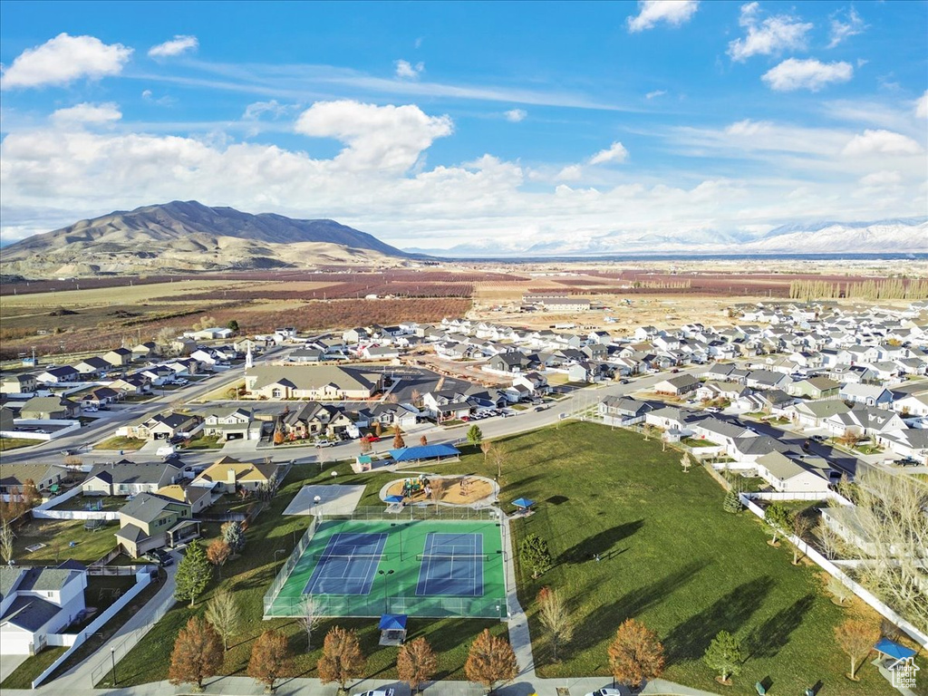 Aerial view of property's location featuring mountains and nearby suburban area