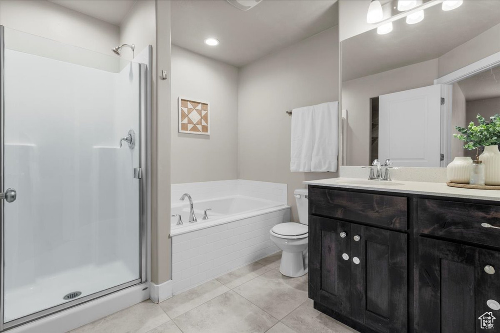 Bathroom with a shower stall, toilet, and a garden tub