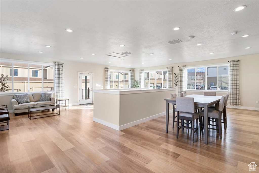Dining space featuring recessed lighting, light wood-type flooring, and baseboards