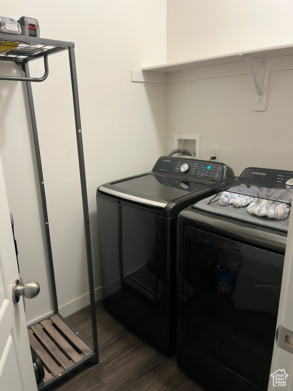 Washroom featuring independent washer and dryer and dark wood-style flooring