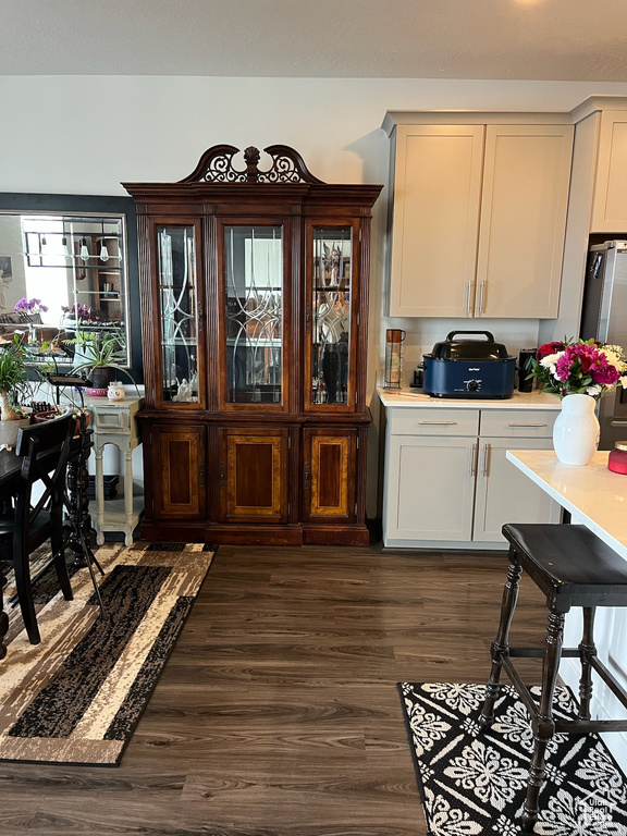 Dining area with dark wood-type flooring