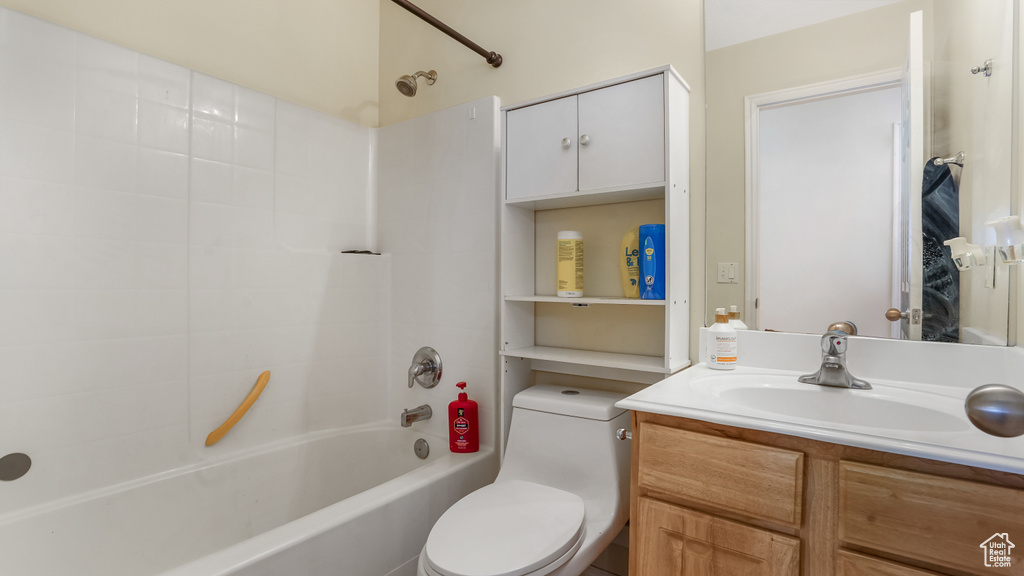 Full bathroom with toilet, vanity, and shower / bath combination