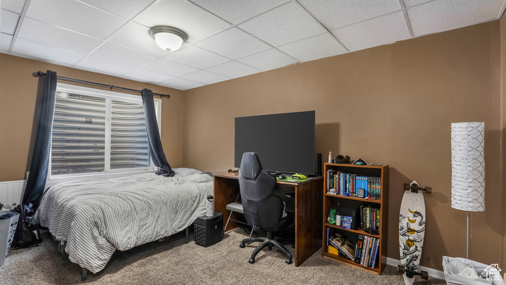 Carpeted bedroom featuring a drop ceiling