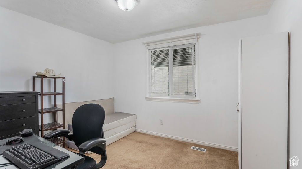 Carpeted office space featuring baseboards