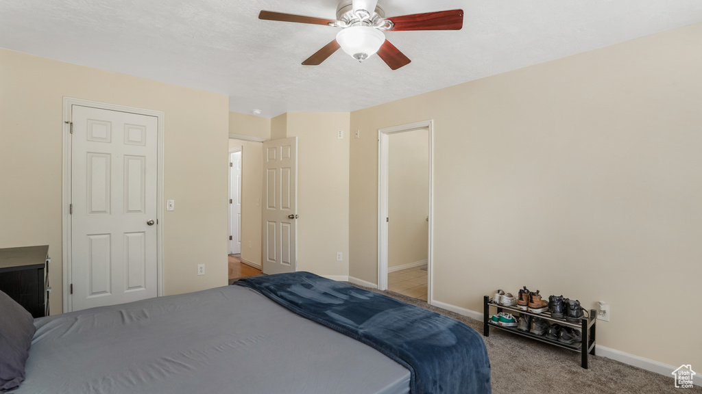 Bedroom featuring carpet, baseboards, and a ceiling fan