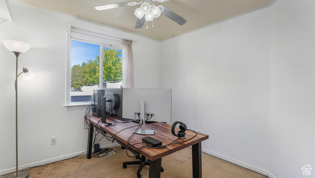 Home office with carpet flooring, a ceiling fan, and baseboards