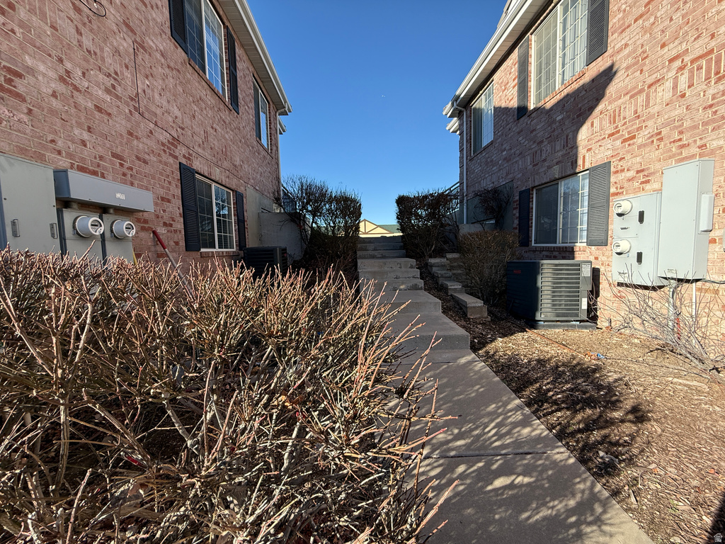 View of property exterior with brick siding