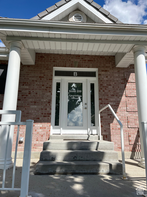Property entrance featuring brick siding