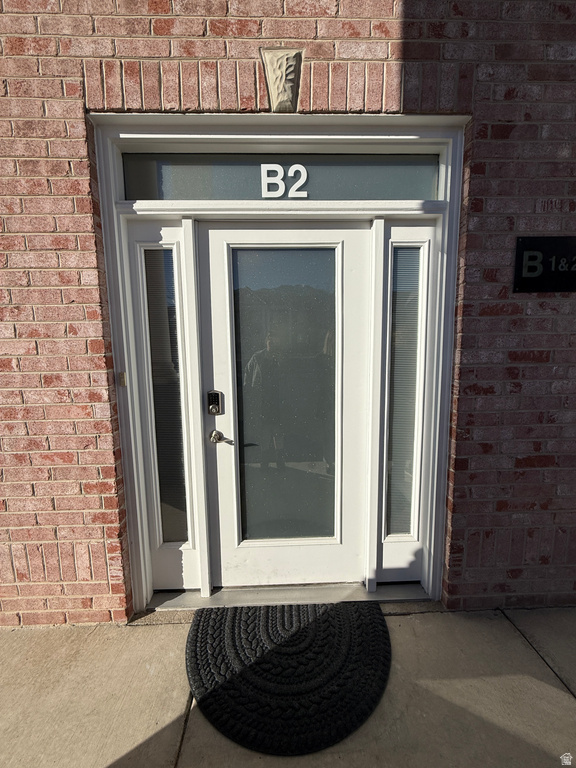 Doorway to property with brick siding